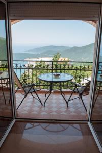a patio with a table and chairs on a balcony at Apartments Villa Sveti Nikola in Budva