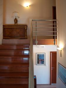 a staircase in a home with wooden stairs and a stair case at Apartments Villa Sveti Nikola in Budva