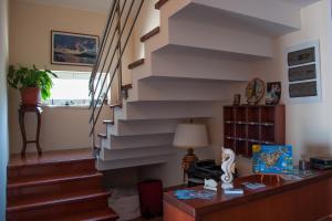 a staircase in a living room with a desk at Apartments Villa Sveti Nikola in Budva