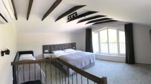 a bedroom with a bed and a large window at Vila JŪRALUX in Palanga +74 photos