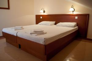 a bedroom with a large bed with two towels on it at Apartments Villa Sveti Nikola in Budva