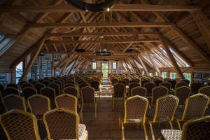 an empty room with rows of chairs in a building at Bekkjarvik Gjestgiveri in Bekkjarvik