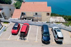 a group of cars parked in a parking lot at Apartments Villa Sveti Nikola in Budva