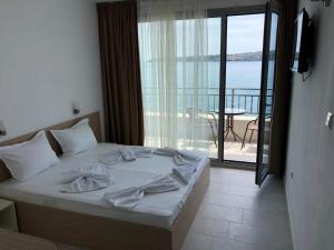 a bedroom with a bed with a view of the ocean at HARMONY in Sozopol