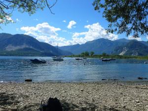 a group of boats on a lake with mountains at La Locanda Al Lago in Verbania