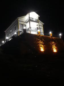 a white house with lights on top of a hill at EYLA VİLLA in Trabzon