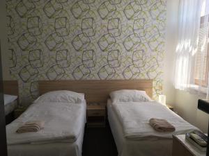 Postel nebo postele na pokoji v ubytování Hotel Jordánek