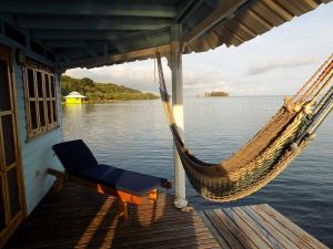 a hammock on the back of a boat on the water at Mango Creek Lodge in Port Royal