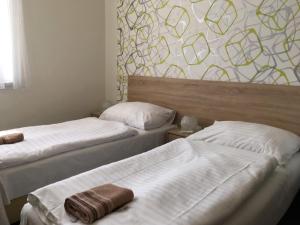 Postel nebo postele na pokoji v ubytování Hotel Jordánek
