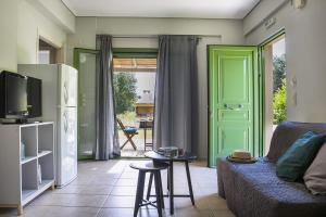 a living room with a couch and a green door at Earth Apartment in Katelios