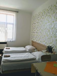Postel nebo postele na pokoji v ubytování Hotel Jordánek