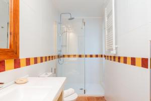 a white bathroom with a shower and a sink at Miragaia House in Porto