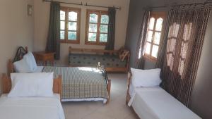 Katil atau katil-katil dalam bilik di Ecolodge Espace Tamount