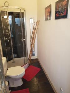 a bathroom with a toilet and a glass shower at Le Nid des Oiseaux in Cubjac