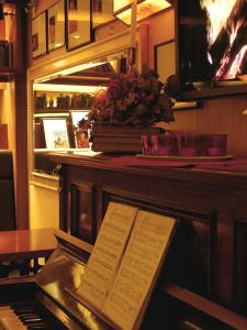 a piano sitting on top of a wooden table at Hotel Schere in Northeim