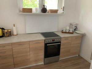 a kitchen with a stove and a counter top at Rytel Zapora 36 in Rytel