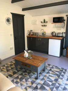 a kitchen with a coffee table in a room at Star Cabin Lairg in Lairg