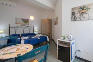 a room with two beds and a table and a bike on the wall at The 5 Terre in Riomaggiore