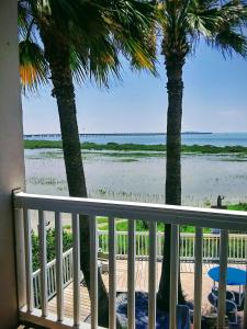 a balcony with a view of the beach at Blue Bay Inn and Suites in South Padre Island