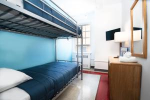 a bedroom with a bunk bed and a mirror at West Side YMCA in New York