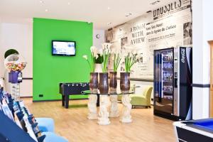 a room with a table with vases of flowers on it at Hotel Siru in Brussels