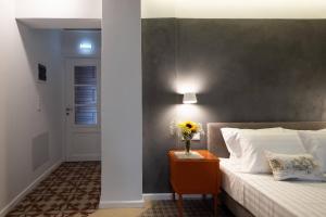 A bed or beds in a room at ATHENIAN YARD SUITES