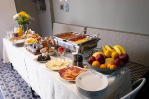 a table with a buffet of food on it at ATHENIAN YARD SUITES in Athens