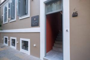 The facade or entrance of ATHENIAN YARD SUITES