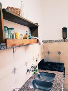 cocina con fregadero y fogones en Light Apartment Alto Palermo en Buenos Aires