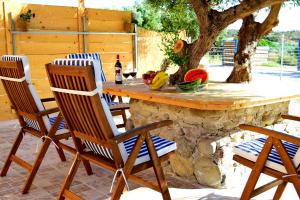 two chairs and a table on a patio at Sea Lake Holiday House in Elafonisi