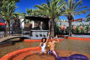 two people in the water at a resort at Very Chic Bodrum Adult Only in Gümbet