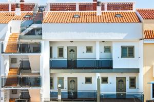 a white building with red tile roofs at Apartamento Ocean Vista in Cotillo