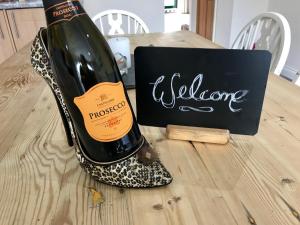 a bottle of wine sitting on top of a table at Westwood Barn Holiday Let in Brough Sowerby