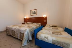 Un pat sau paturi într-o cameră la Hotel Fonte Angelica