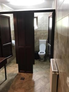 モイエチウ・デ・ジョスにあるVila Moganのバスルーム(トイレ付)、木製のドアが備わります。