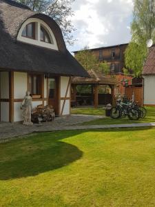 a house with two bikes parked outside of it at Chata Pod Strzechą in Lipusz