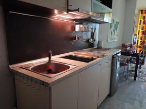 a kitchen with a red sink and a stove at Silver Beach Delux Apartments in Byala