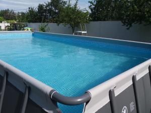 ein großer Pool mit blauem Wasser in einem Gebäude in der Unterkunft Casa LariCris in Corbu