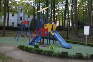 a playground with a slide in a park at Apartament Cesarski Agnes- bezpłatny parking- Resort Cesarskie Ogrody in Świnoujście