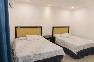 Postel nebo postele na pokoji v ubytování Micro Hotel Rio de Piedras