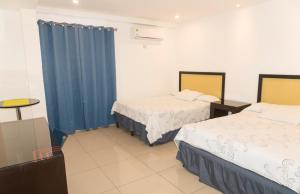 Postel nebo postele na pokoji v ubytování Micro Hotel Rio de Piedras