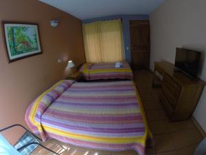 Voodi või voodid majutusasutuse Hotel Guadalupe toas