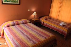 Voodi või voodid majutusasutuse Hotel Guadalupe toas