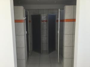 a corridor of a bathroom with two open doors at Antares Paracas in Paracas