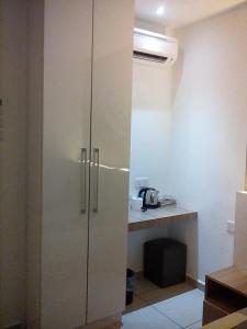 a white cabinet in a room with a desk at Rivero Boutique Hotel Melaka in Malacca +36 photos