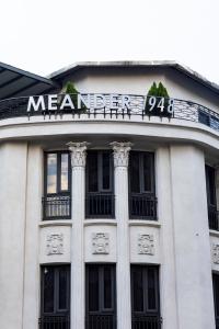 a building with a sign on top of it at Meander 1948 Hostel - Taipei Main Station in Taipei