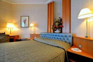 a bedroom with a blue bed in a hotel room at Hotel Ristorante Al Sorriso in Soriso