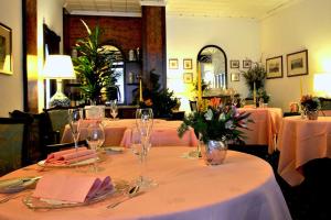 a table with wine glasses and flowers on it at Hotel Ristorante Al Sorriso in Soriso