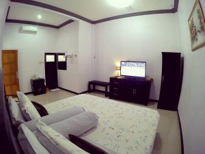 Letto o letti in una camera di Amaryllis Guesthouse Syariah