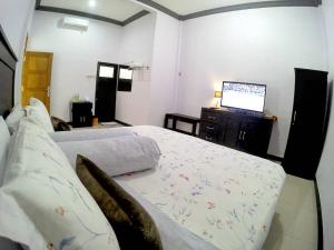 Letto o letti in una camera di Amaryllis Guesthouse Syariah